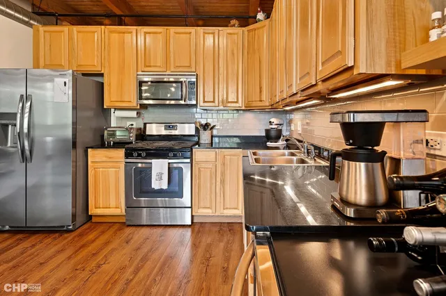 a kitchen with a refrigerator stove and microwave