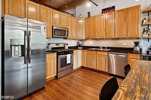 a bedroom with bed painting on wall and a potted plant