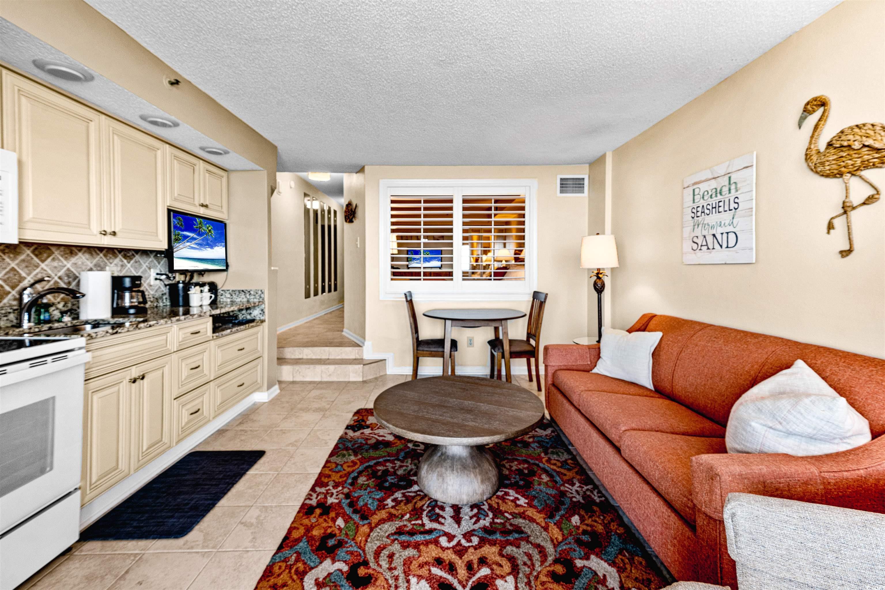 5308 North Ocean Boulevard, Unit 2006 Myrtle Beach, SC 29577 - Photo 12 of 37 Living area with light tile patterned flooring and a textured ceiling