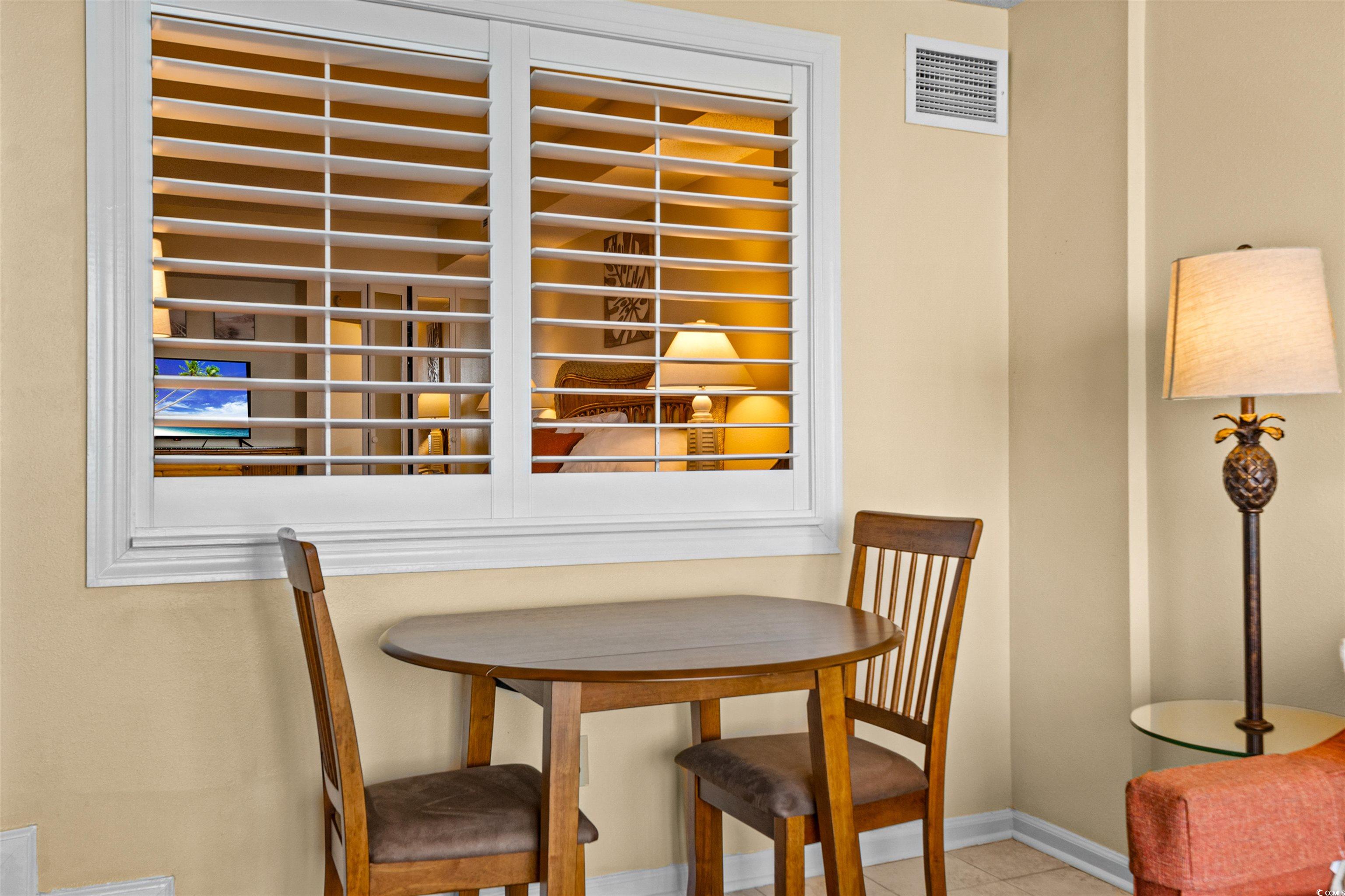 5308 North Ocean Boulevard, Unit 2006 Myrtle Beach, SC 29577 - Photo 13 of 37 View of dining area and shuttered window looking into the bedroom