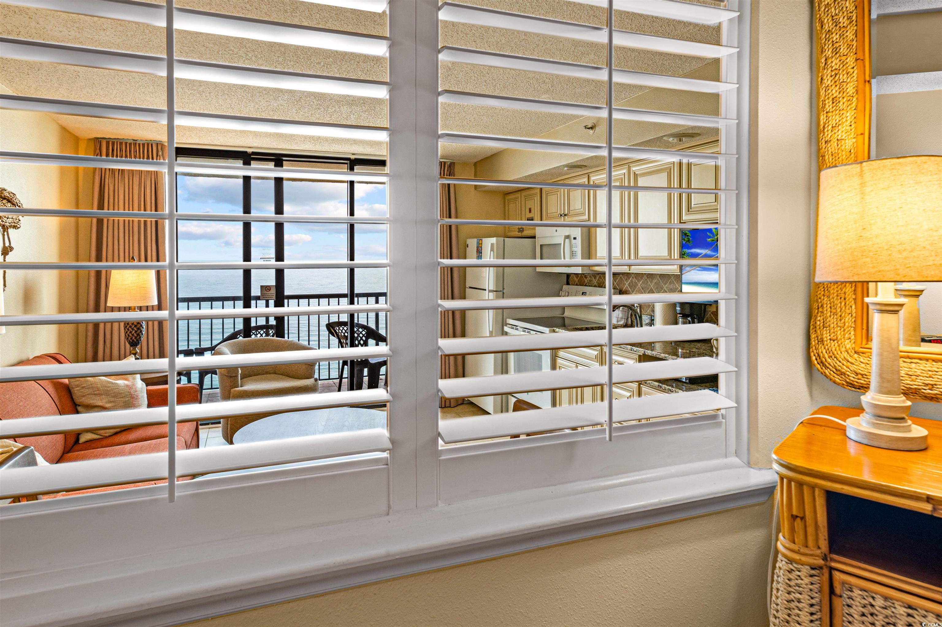 5308 North Ocean Boulevard, Unit 2006 Myrtle Beach, SC 29577 - Photo 14 of 37 Shuttered window looking out from the bedroom with ocean views