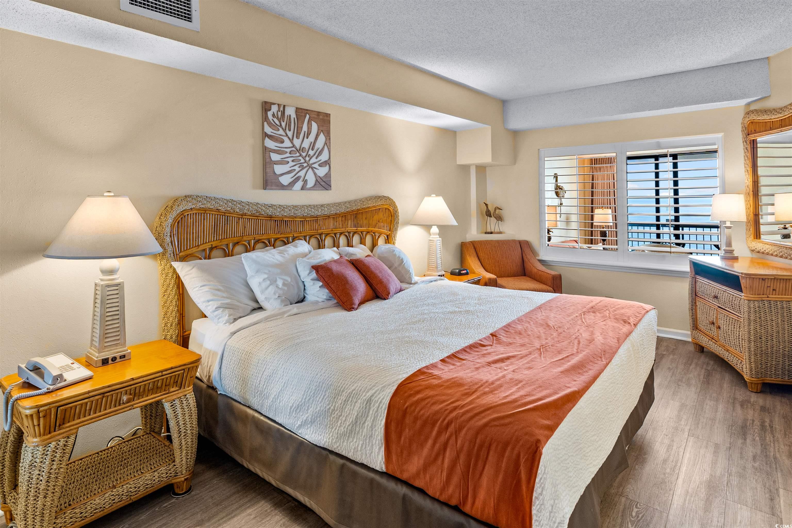 5308 North Ocean Boulevard, Unit 2006 Myrtle Beach, SC 29577 - Photo 15 of 37 Bedroom featuring ocean views and LVP flooring