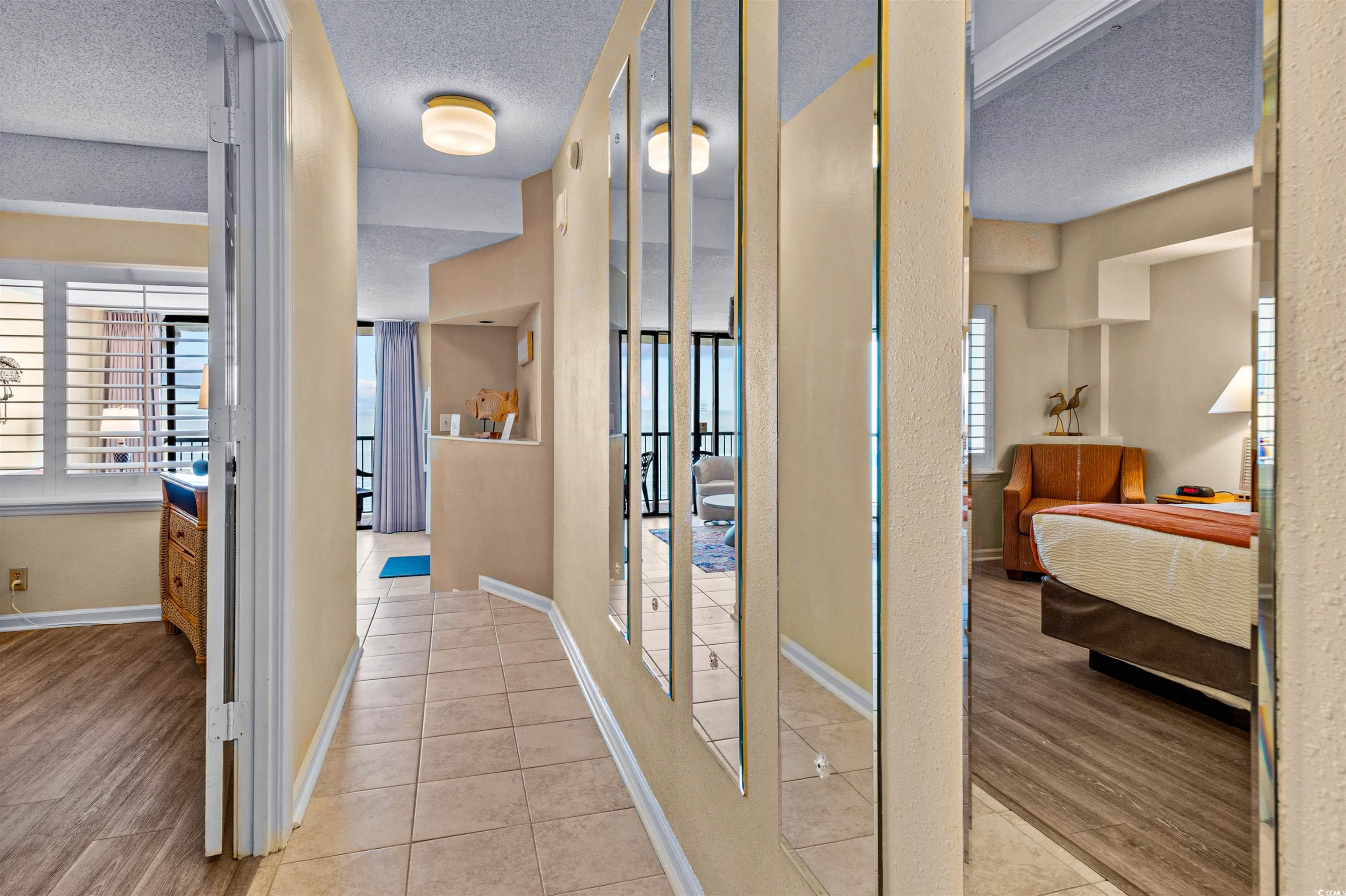 5308 North Ocean Boulevard, Unit 2006 Myrtle Beach, SC 29577 - Photo 18 of 37 Hall featuring foyer entry, tile floors, and textured ceilings