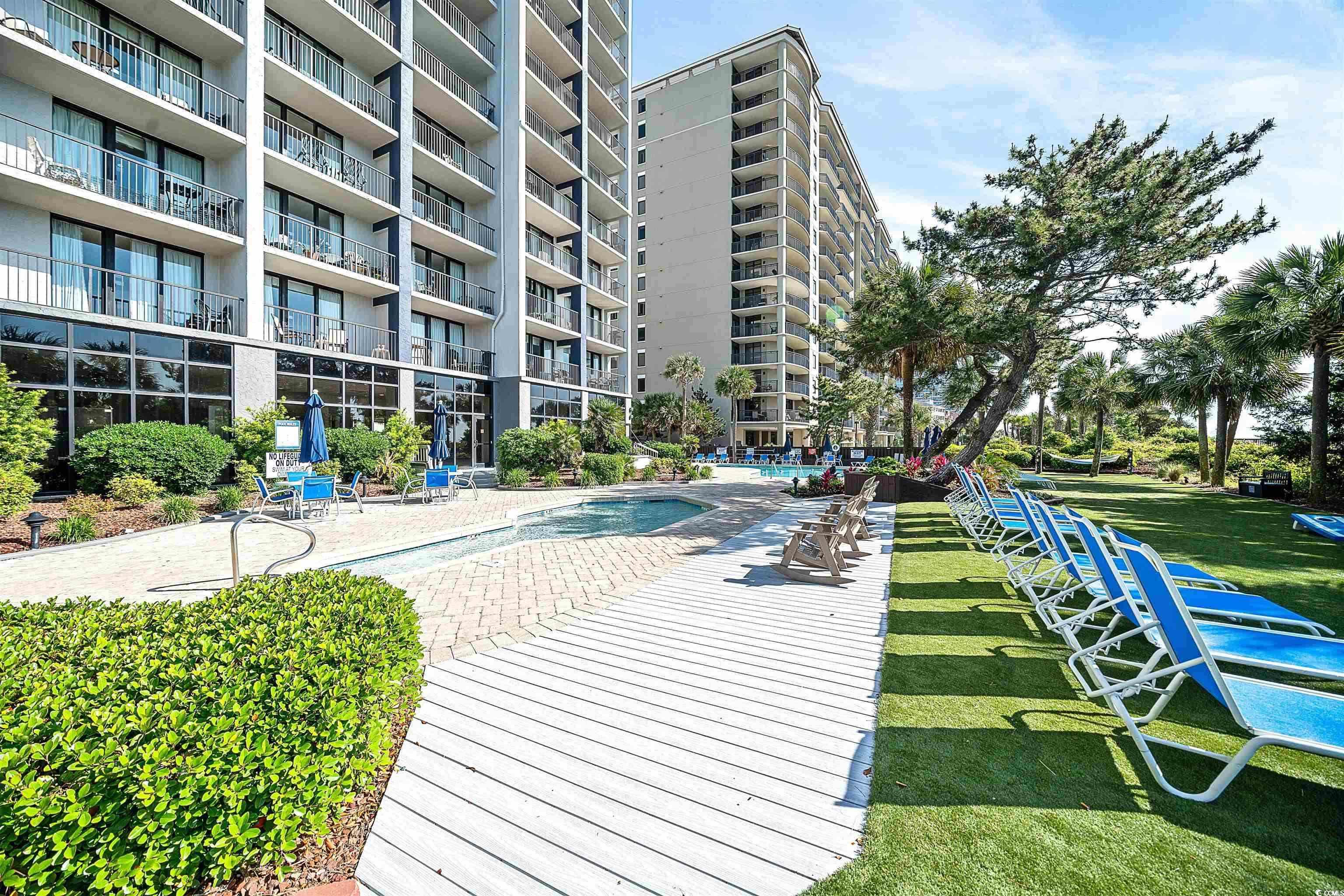 5308 North Ocean Boulevard, Unit 2006 Myrtle Beach, SC 29577 - Photo 27 of 37 View of resort lawn, loungers, and pool area