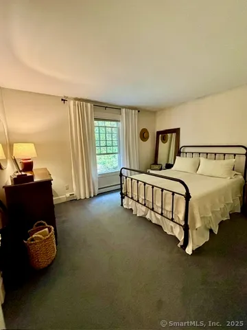 a bed room with a bed and a chair