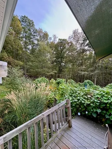 a view of a yard with wooden fence
