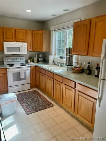 a kitchen with sink cabinets and window