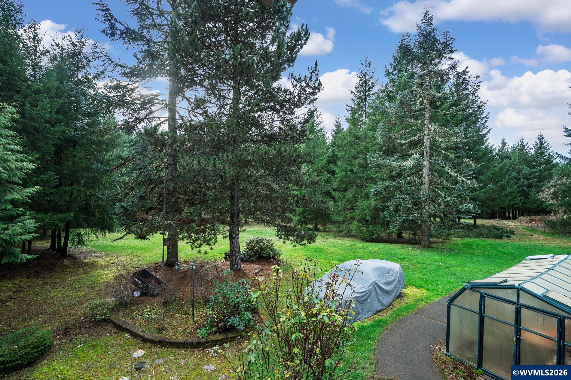 27572 South Kinzy Road Estacada, OR 97023 - Photo 47 of 50 a view of a garden with plants and large trees