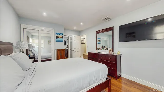 a bedroom with a bed and a dresser