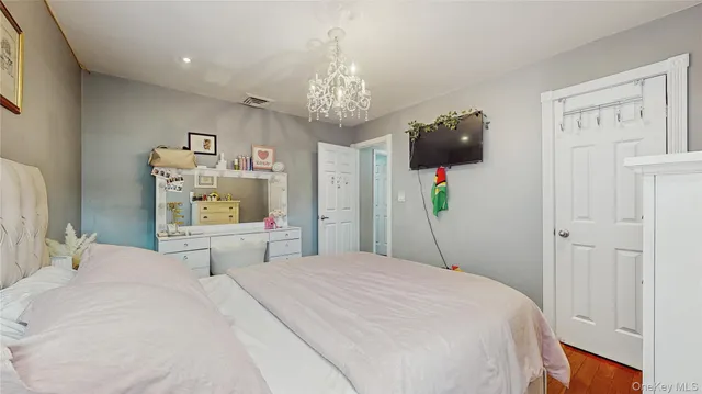 a bedroom with a bed and a chandelier