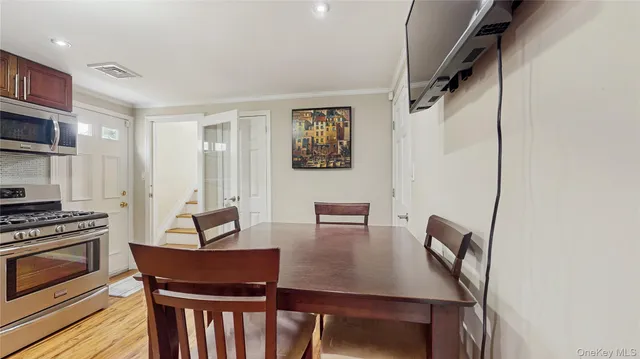 a kitchen with stainless steel appliances a refrigerator and microwave