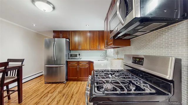 a view of a dining room with furniture and a kitchen