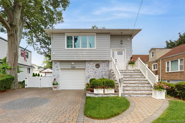 a front view of a house with a garden and plants