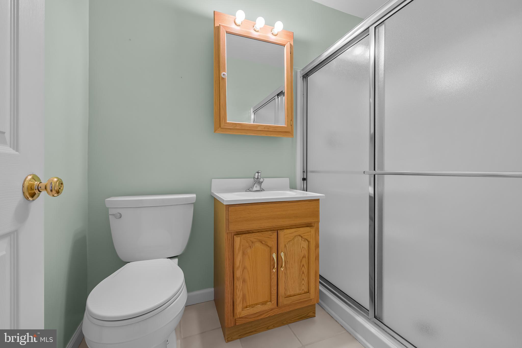 2502 Raven Road Wilmington, DE 19810 - Photo 23 of 57 a bathroom with a toilet a sink and mirror