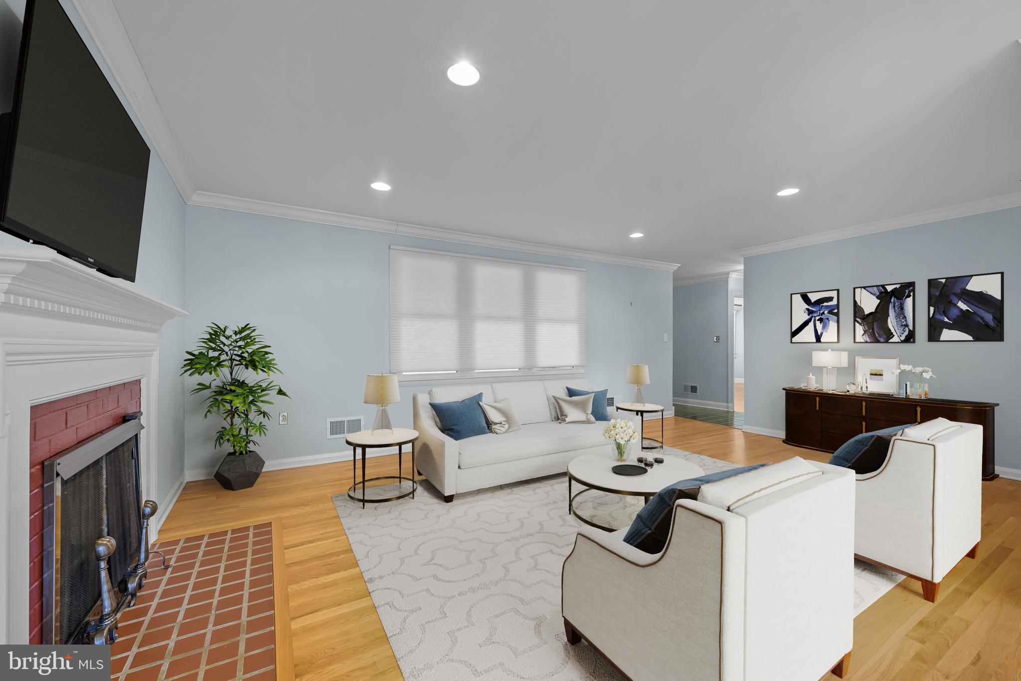 2502 Raven Road Wilmington, DE 19810 - Photo 3 of 57 a living room with furniture a flat screen tv and a fireplace