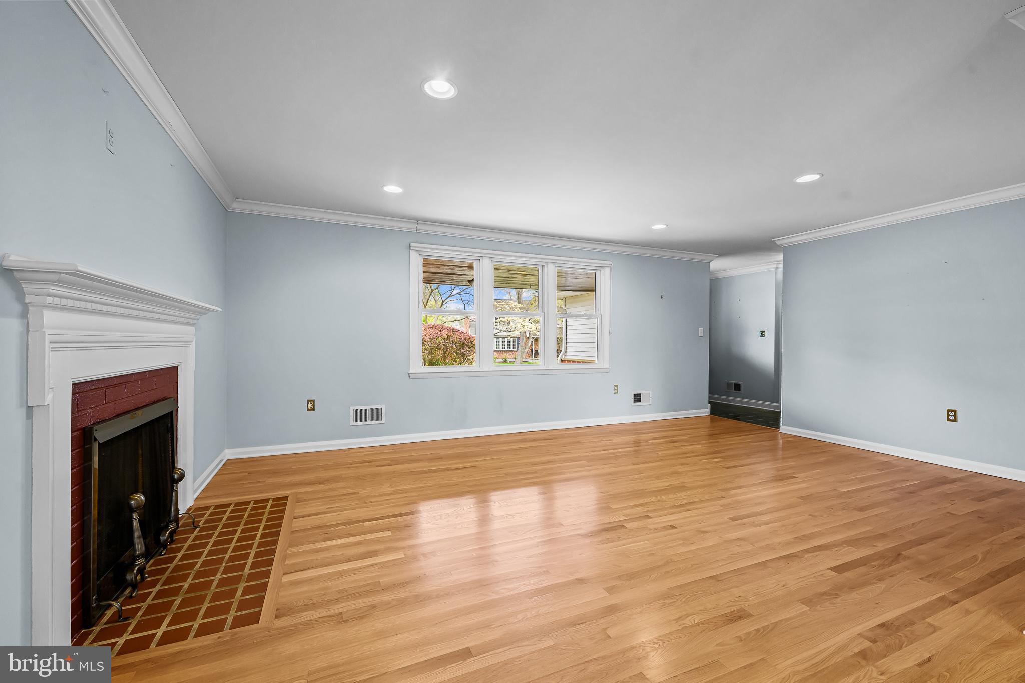 2502 Raven Road Wilmington, DE 19810 - Photo 31 of 57 a view of an empty room with wooden floor and a fireplace
