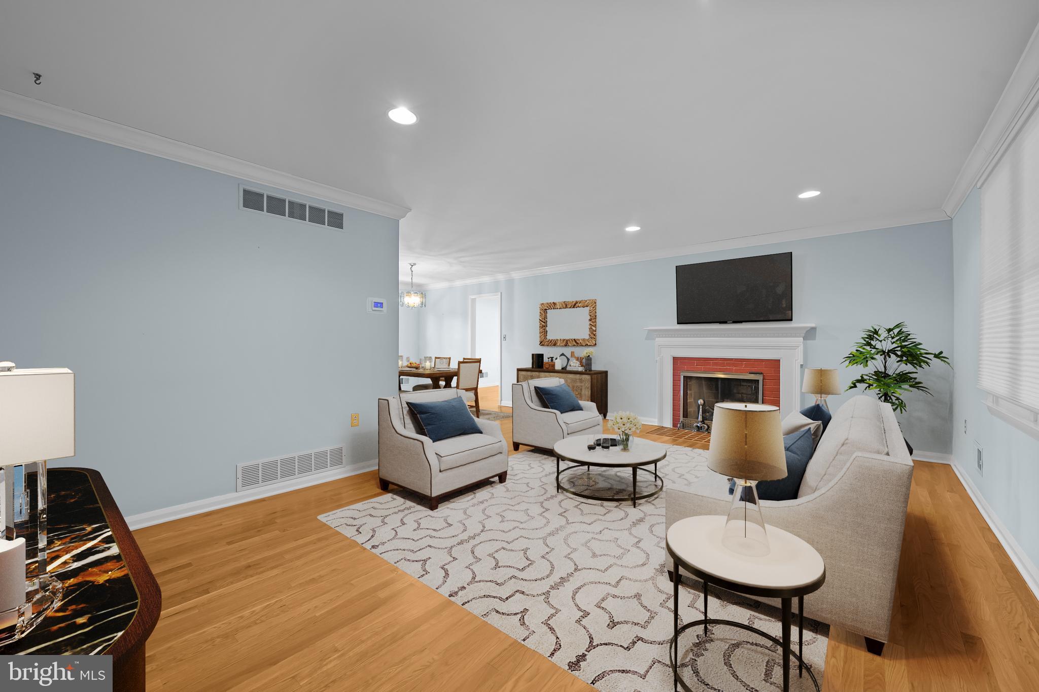 2502 Raven Road Wilmington, DE 19810 - Photo 4 of 57 a living room with furniture a fireplace and a flat screen tv