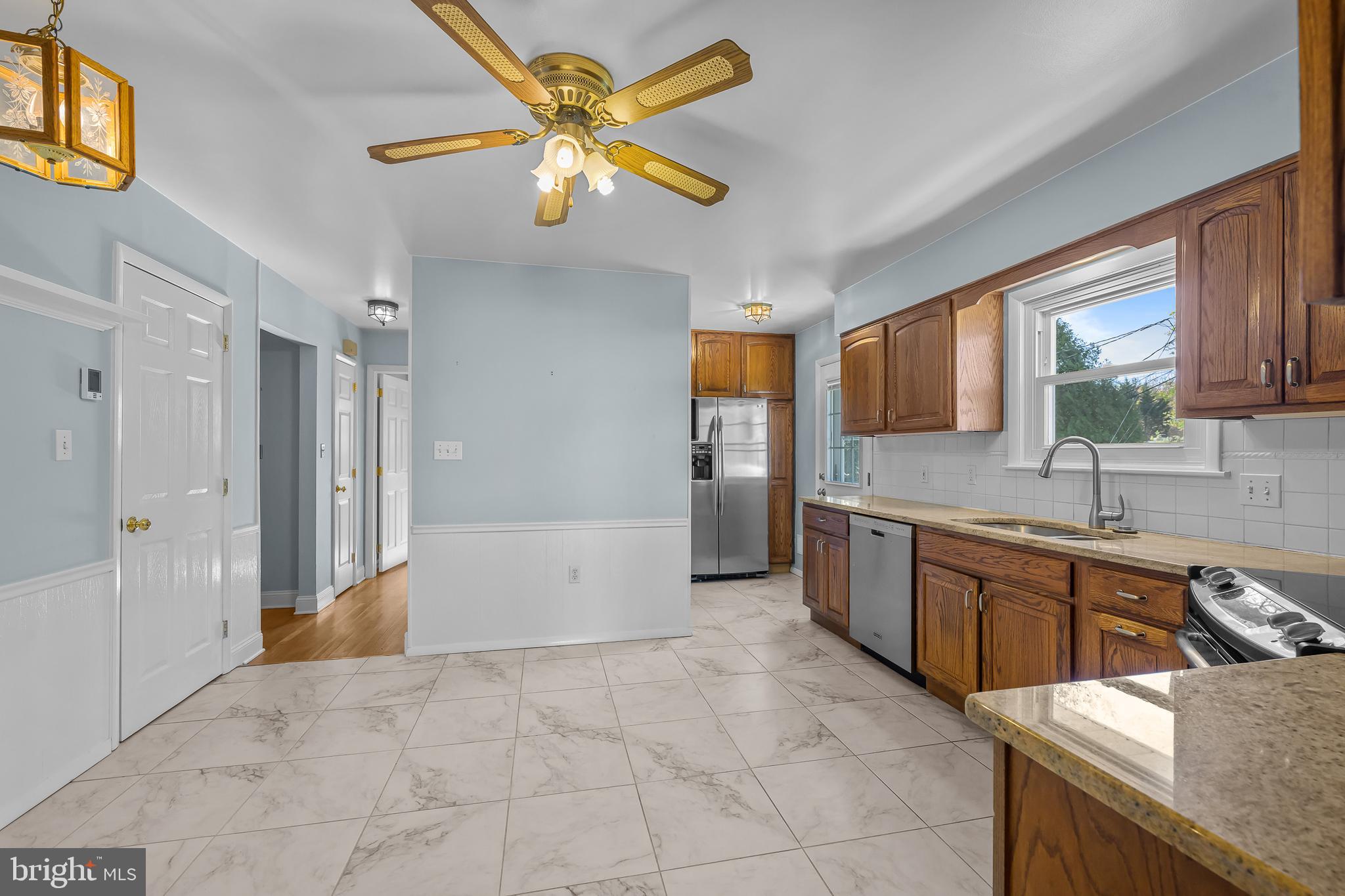 2502 Raven Road Wilmington, DE 19810 - Photo 9 of 57 a large kitchen with kitchen island a sink stainless steel appliances and cabinets