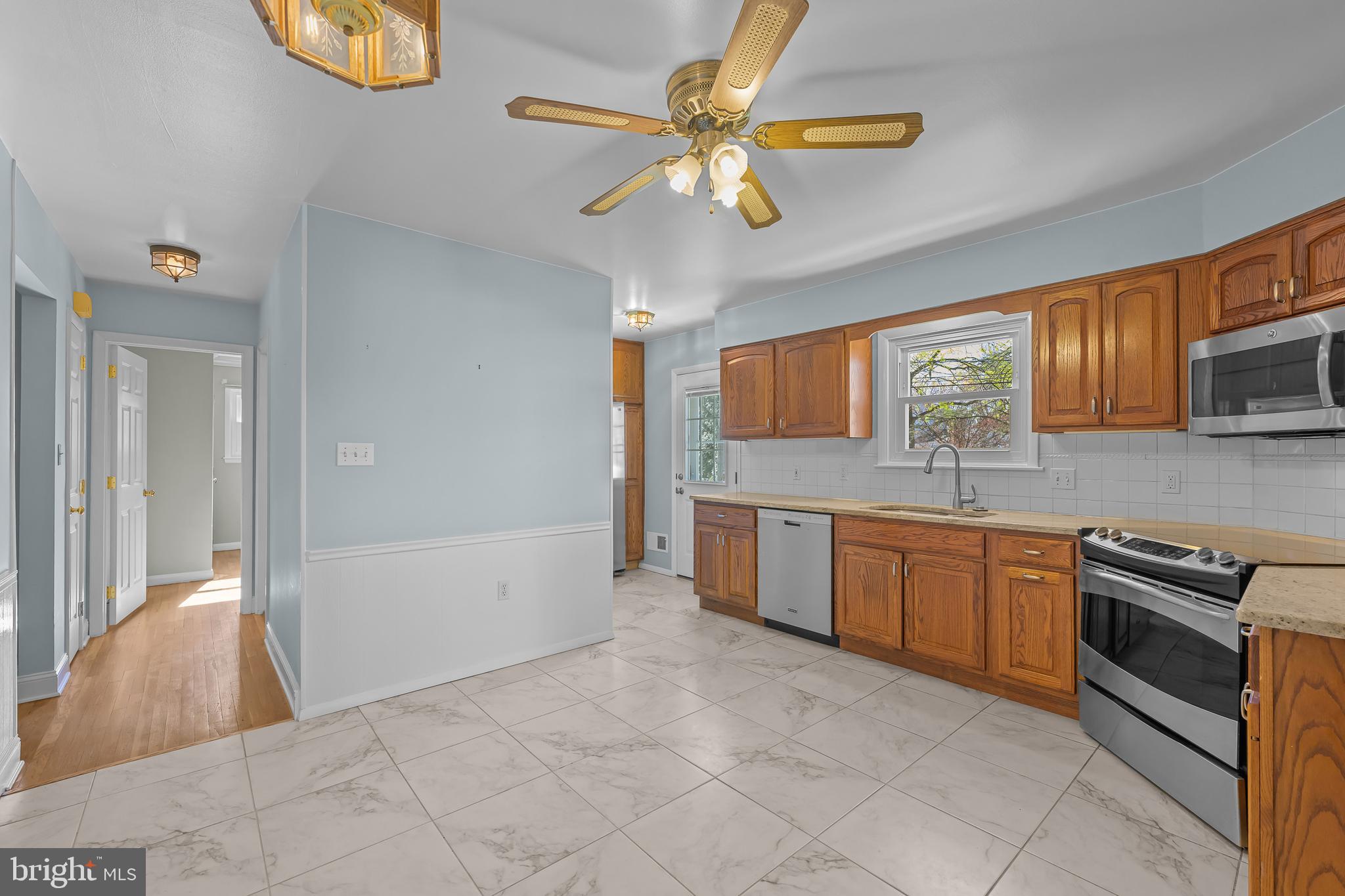 2502 Raven Road Wilmington, DE 19810 - Photo 10 of 57 a kitchen with stainless steel appliances granite countertop a refrigerator and a sink