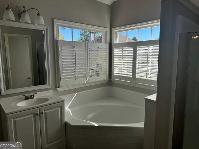 a bathroom with a bathtub and a sink