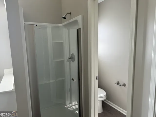 a bathroom with a toilet tub and a shower