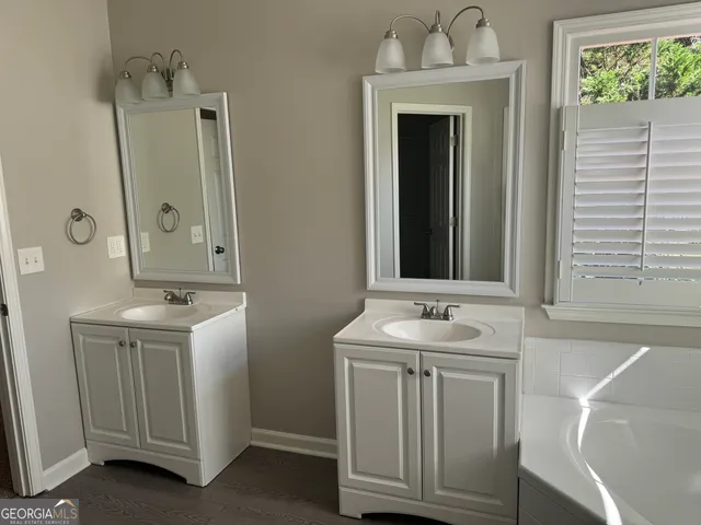 a bathroom with a sink vanity and a mirror