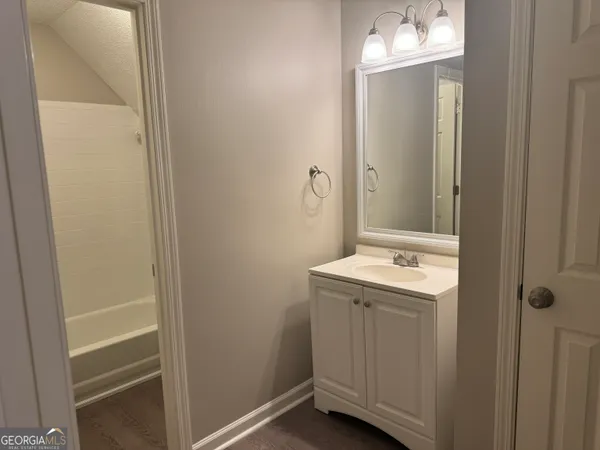 a bathroom with a sink a toilet and vanity