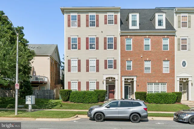 a car parked in front of a brick house