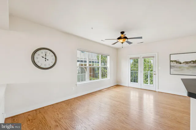 a kitchen with granite countertop a stove and white cabinets with wooden floor