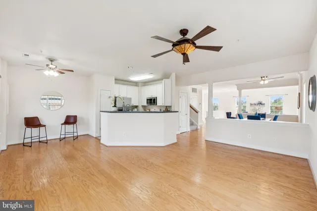 a view of a kitchen with wooden floor and a window