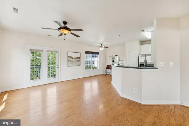 a kitchen with white cabinets sink and stainless steel appliances
