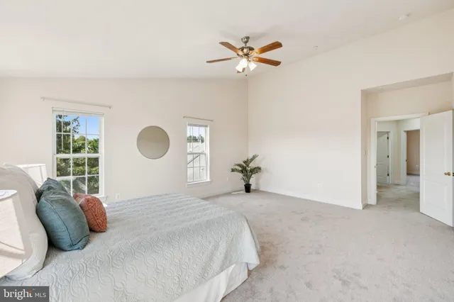 a bedroom with a bed and a potted plant