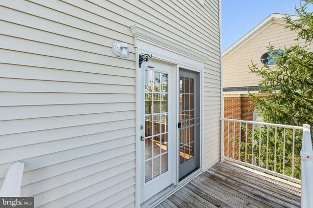 a view of a balcony with wooden floor and fence