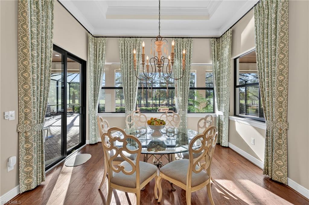 14495 Marsala Way Naples, FL 34109 - Photo 13 of 45 a view of a dining room with furniture large windows and wooden floor