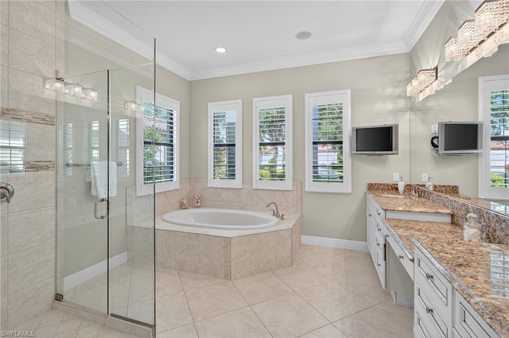 14495 Marsala Way Naples, FL 34109 - Photo 18 of 45 a spacious bathroom with a tub sink a mirror and a shower