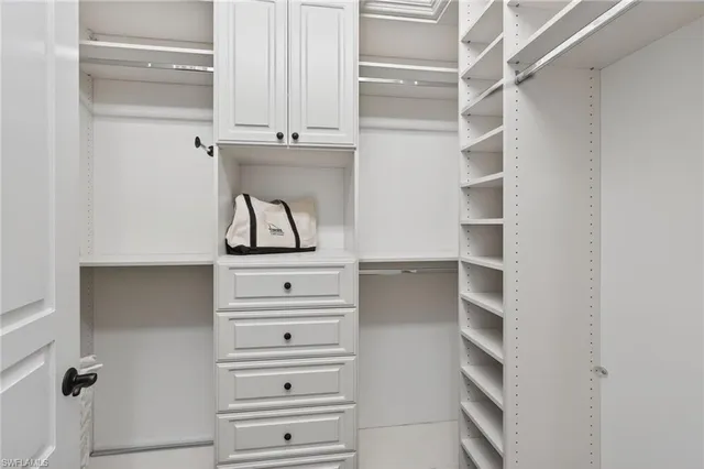 a view of walk in closet with empty racks