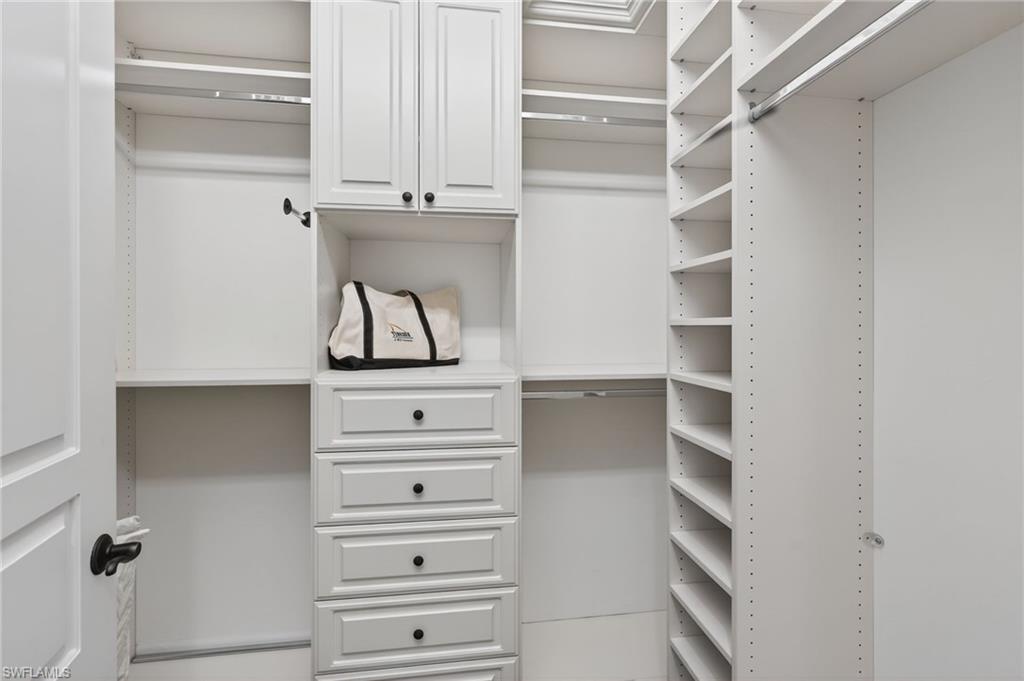 14495 Marsala Way Naples, FL 34109 - Photo 21 of 45 a view of walk in closet with empty racks