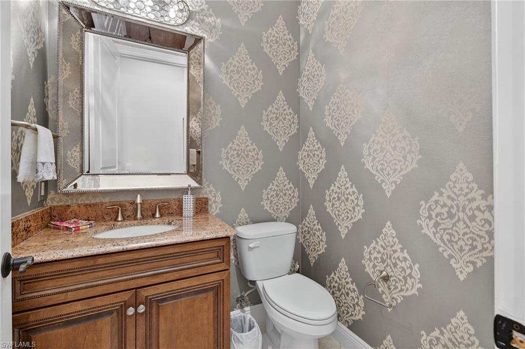 14495 Marsala Way Naples, FL 34109 - Photo 24 of 45 a bathroom with a toilet and a shower curtain