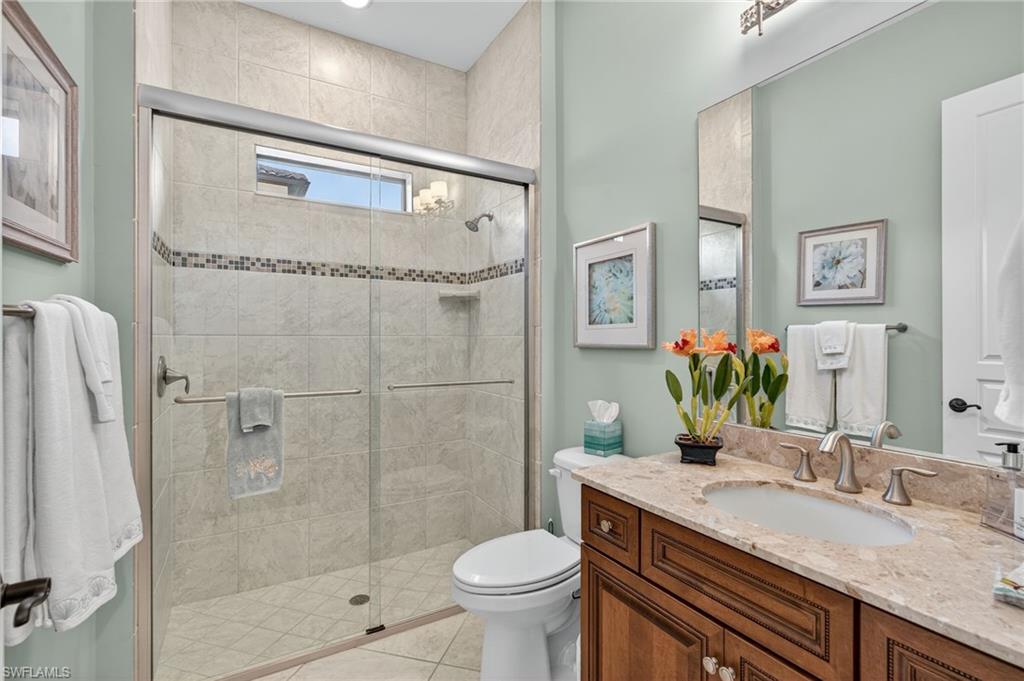 14495 Marsala Way Naples, FL 34109 - Photo 28 of 45 a bathroom with a granite countertop sink toilet and shower