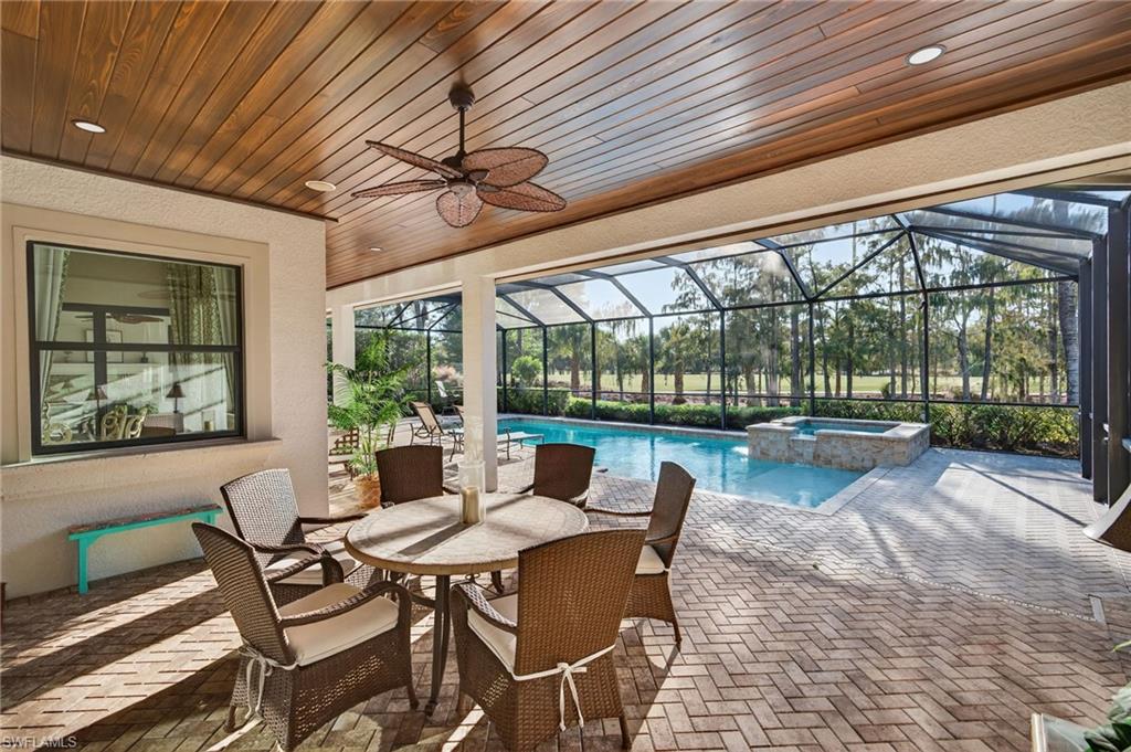 14495 Marsala Way Naples, FL 34109 - Photo 33 of 45 a dining room with furniture wooden floor and a garden view