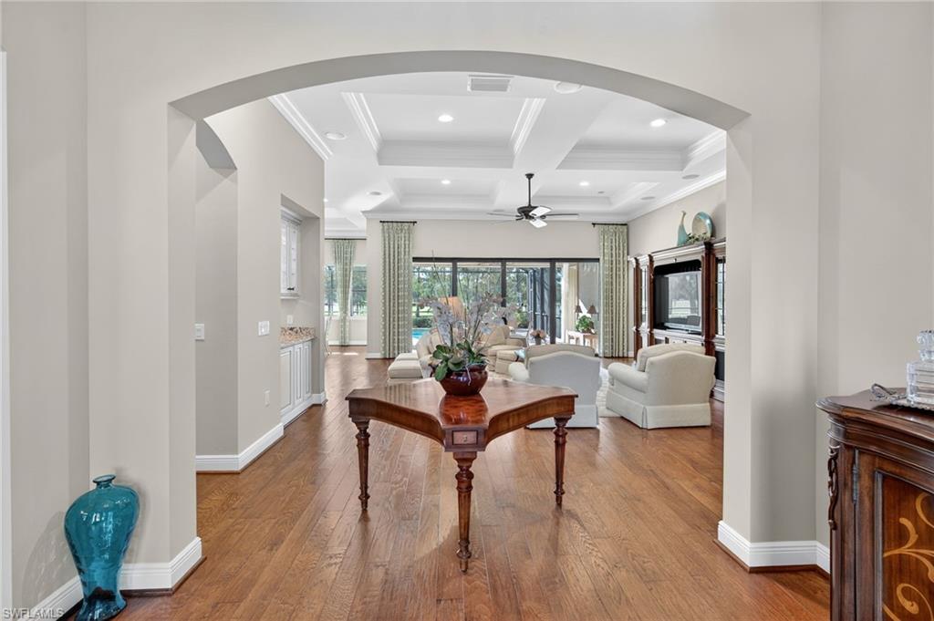 14495 Marsala Way Naples, FL 34109 - Photo 4 of 45 a living room with furniture and a chandelier