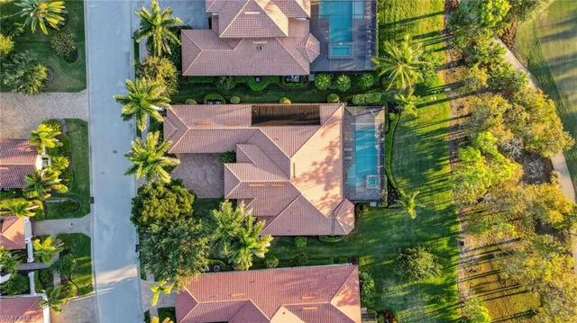 an aerial view of a house with a yard