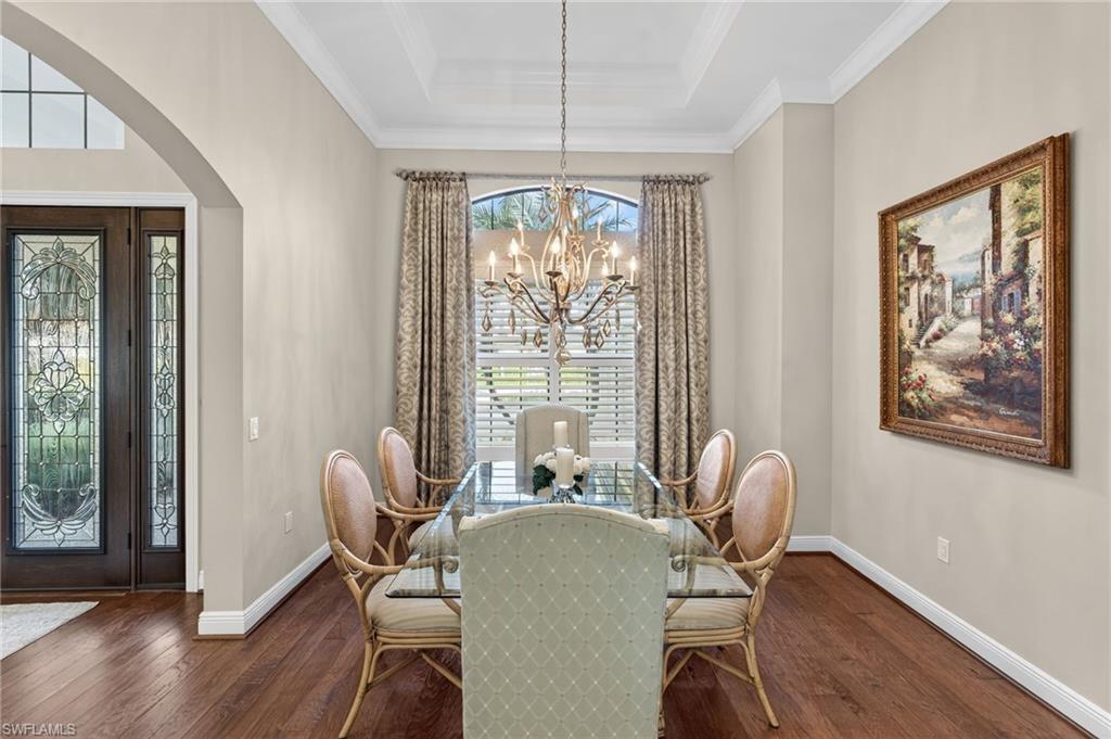 14495 Marsala Way Naples, FL 34109 - Photo 5 of 45 a dining room with furniture a chandelier and wooden floor