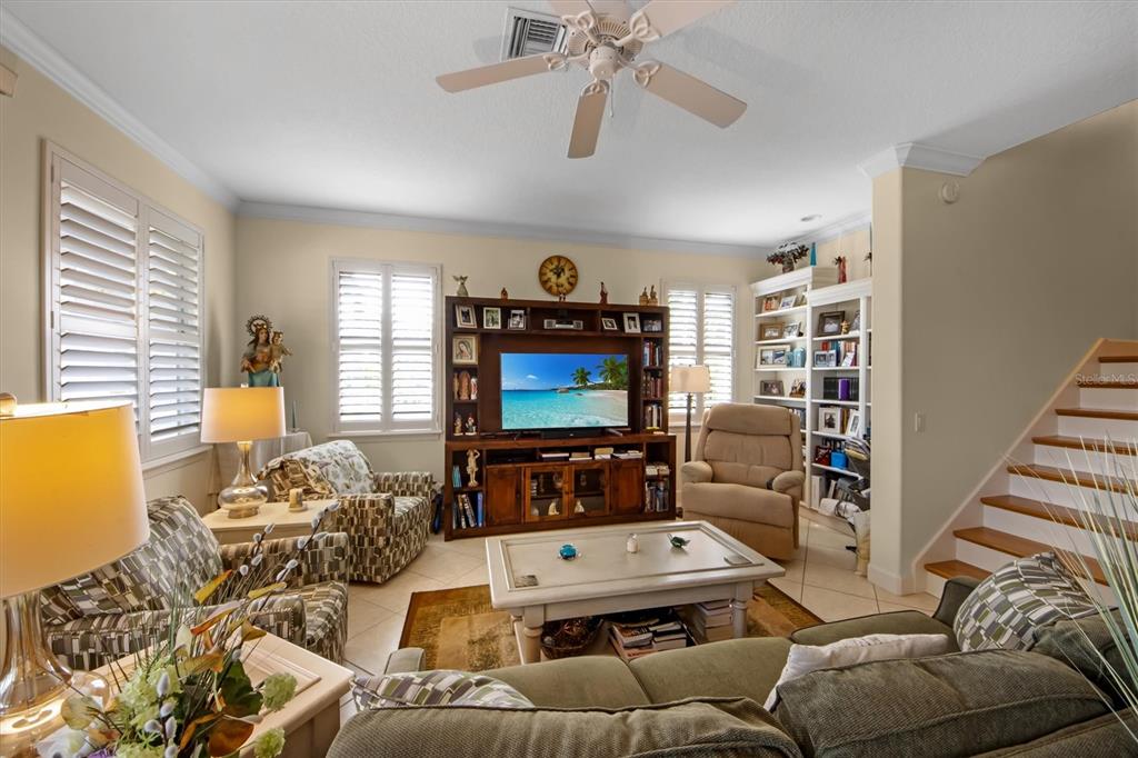 220 82nd Street Holmes Beach, FL 34217 - Photo 17 of 35 a living room with furniture ceiling fan and a window