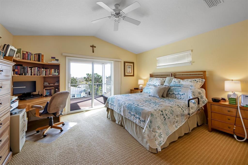 220 82nd Street Holmes Beach, FL 34217 - Photo 20 of 35 a bedroom with a bed a chair and a large window