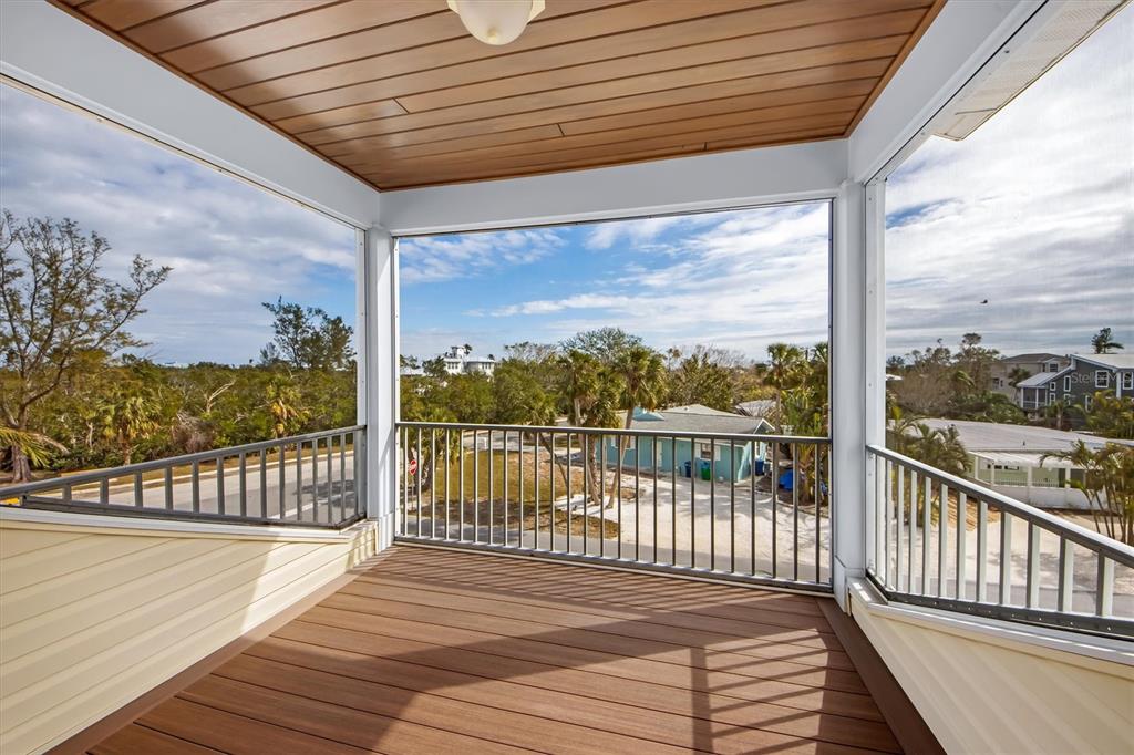 220 82nd Street Holmes Beach, FL 34217 - Photo 22 of 35 a balcony with wooden floor