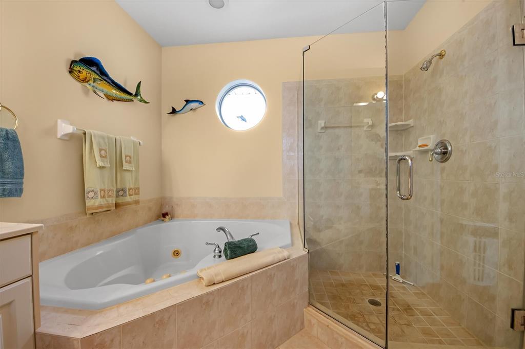 220 82nd Street Holmes Beach, FL 34217 - Photo 24 of 35 a bathroom with a bathtub a sink and a shower