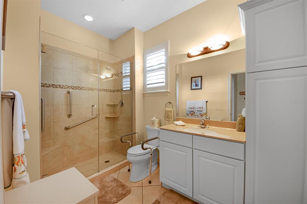 220 82nd Street Holmes Beach, FL 34217 - Photo 7 of 35 a spacious bathroom with a shower sink mirror and toilet