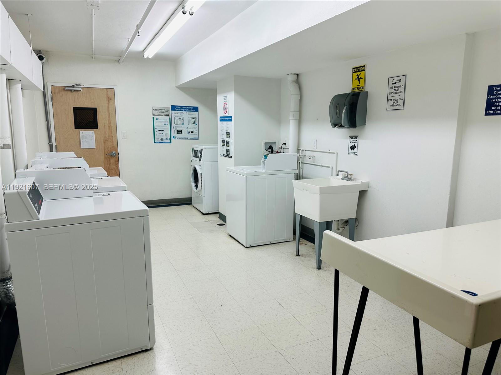 100 Lincoln Road, Unit 1427 Miami Beach, FL 33139 - Photo 17 of 32 a view of storage and utility room with two washing machine