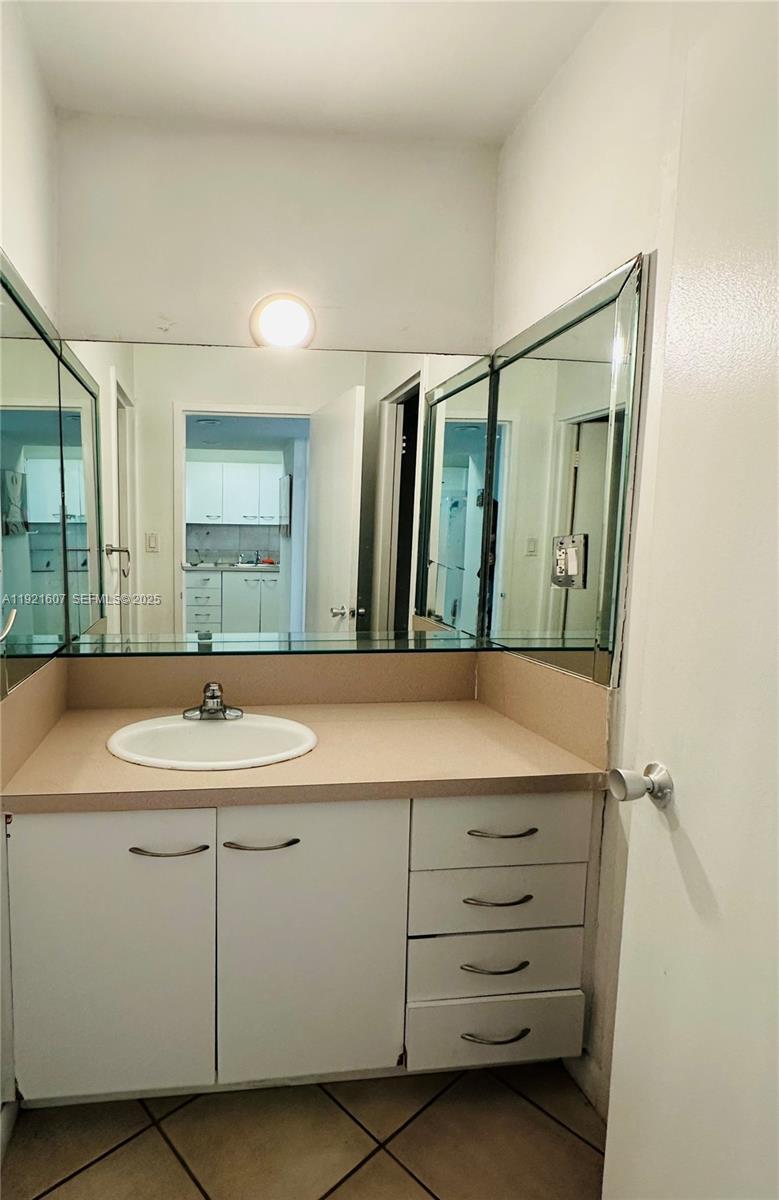 100 Lincoln Road, Unit 1427 Miami Beach, FL 33139 - Photo 24 of 32 a bathroom with a sink and a mirror
